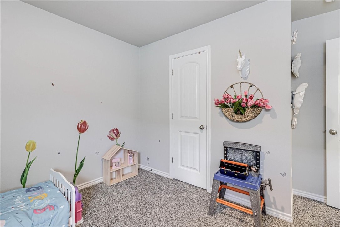 7630 Shadow Rider Lane Corpus Christi, TX 78414 - Photo 33 of 39 a bedroom with furniture and a book shelf
