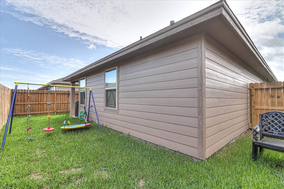 7630 Shadow Rider Lane Corpus Christi, TX 78414 - Photo 38 of 39 a backyard of a house with table and chairs
