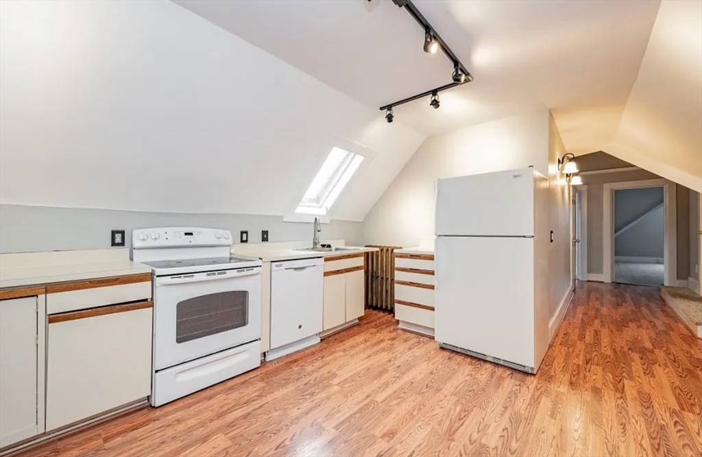 1137 Dwight Street, Unit C Holyoke, MA 01040 - Photo 2 of 9 a kitchen with a stove top oven and refrigerator