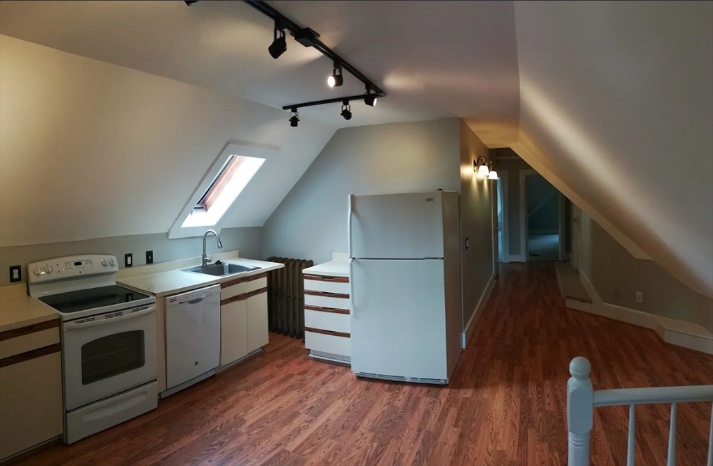 1137 Dwight Street, Unit C Holyoke, MA 01040 - Photo 3 of 9 a kitchen with a stove and a refrigerator