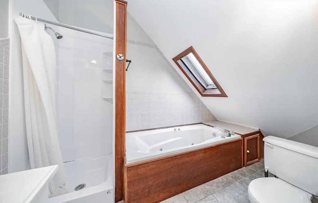 1137 Dwight Street, Unit C Holyoke, MA 01040 - Photo 4 of 9 a bathroom with a tub toilet and sink