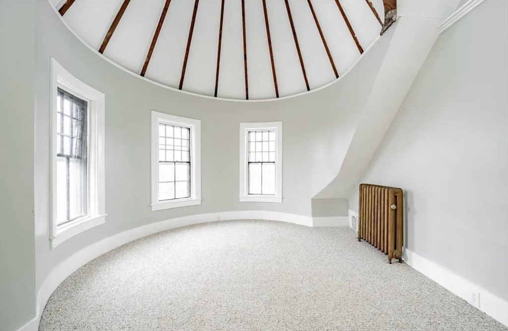 1137 Dwight Street, Unit C Holyoke, MA 01040 - Photo 9 of 9 an empty room with windows and closet