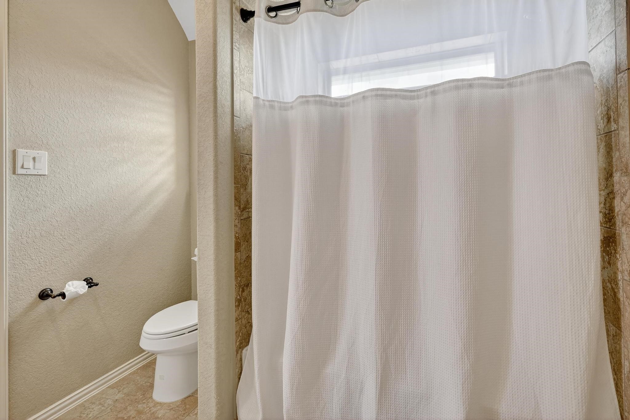 25803 Heritage Maple Drive Spring, TX 77389 - Photo 31 of 46 a bathroom with a shower curtain