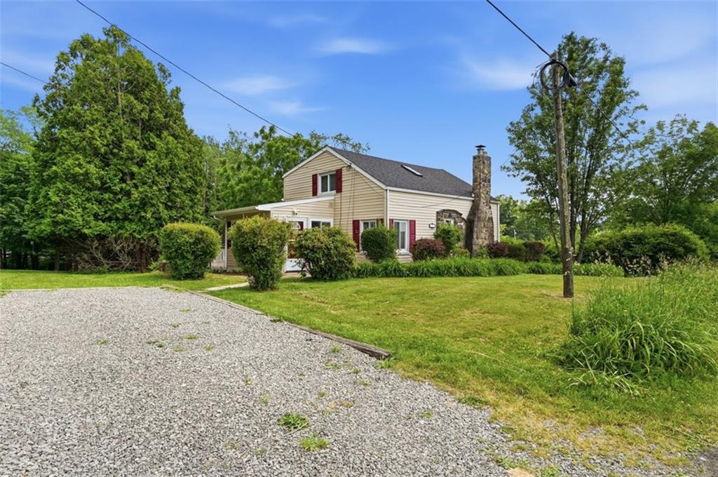 123 Cemetery Road Slippery Rock, PA 16057 - Photo 30 of 33 Set on a beautifully landscaped lot, this home offers timeless curb appeal, mature trees, and a spacious yard with room to relax and play. The extra driveway provides ample parking.