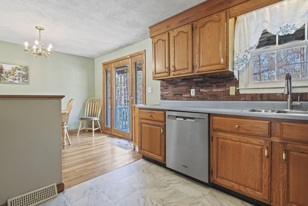 15 Proctor Road Townsend, MA 01469 - Photo 9 of 40 a kitchen with stainless steel appliances granite countertop a stove and cabinets