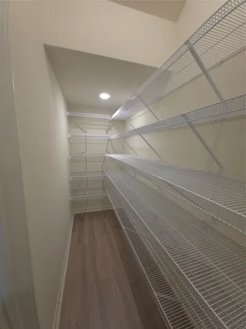 a view of a room with wooden floor