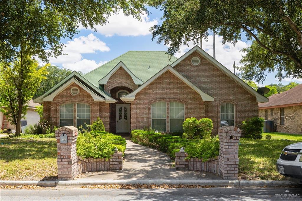 a front view of a house with garden