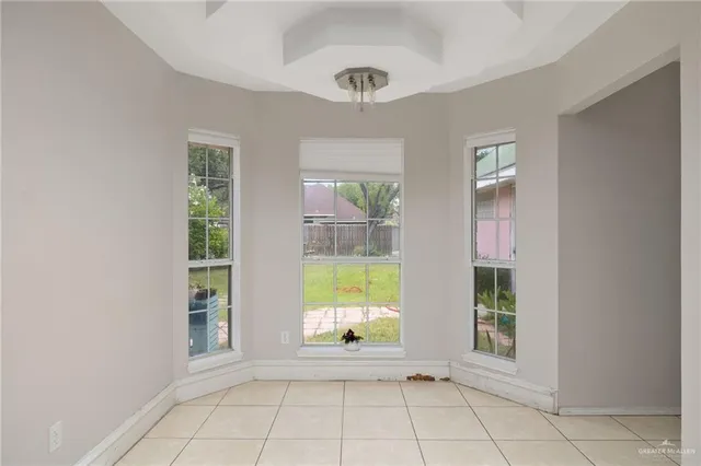 a kitchen with cabinets stainless steel appliances and a window