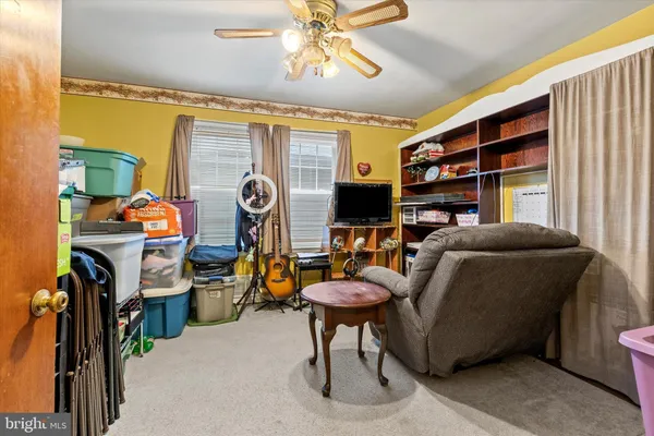 a living room with furniture a chandelier and a flat screen tv
