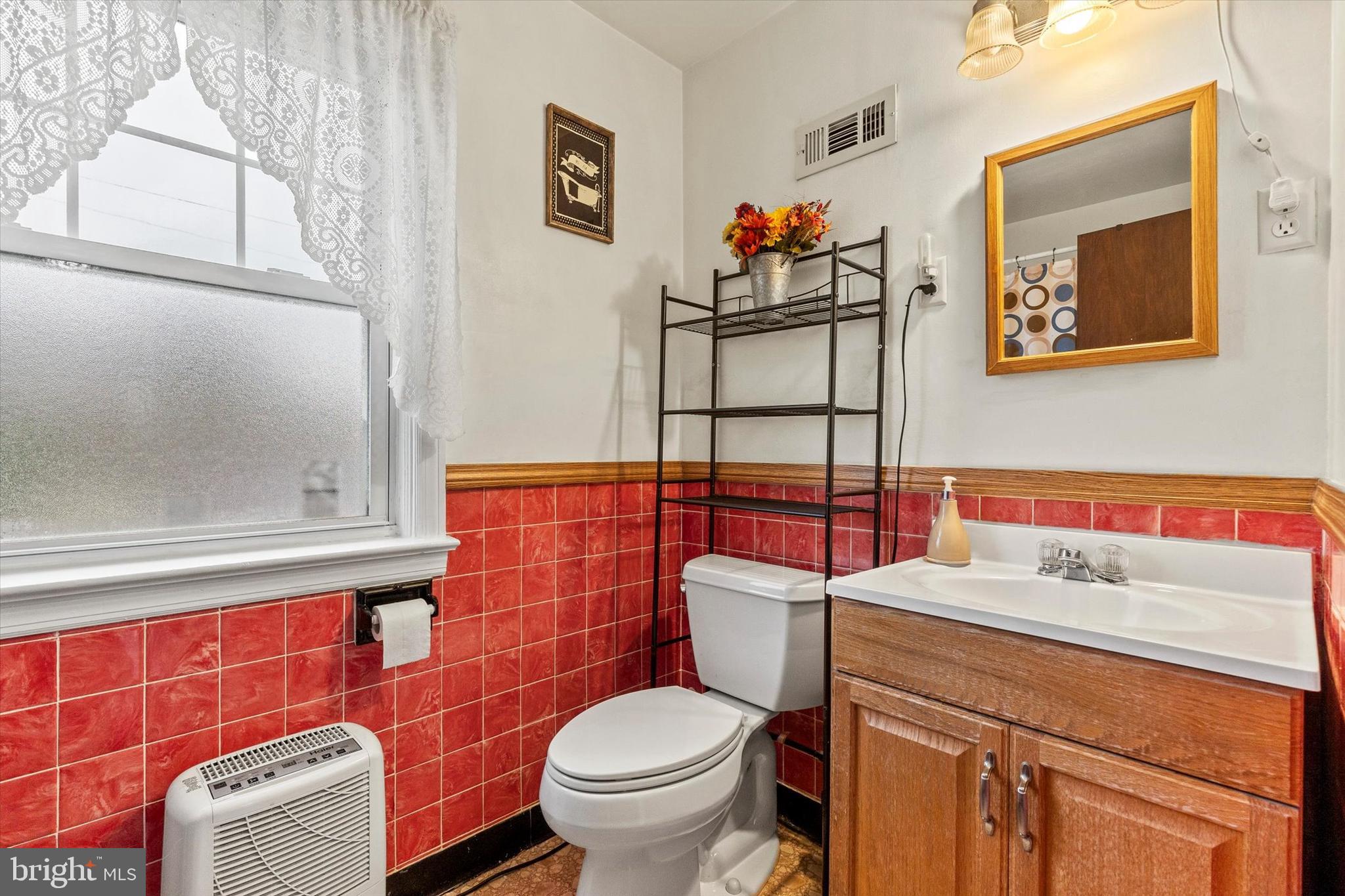 33 North Adams Street York, PA 17404 - Photo 20 of 42 a bathroom with a toilet a sink and a shower curtain