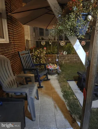 a view of a chairs and table in backyard