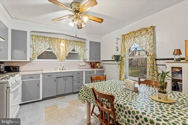 a kitchen with a table chairs stove and cabinets