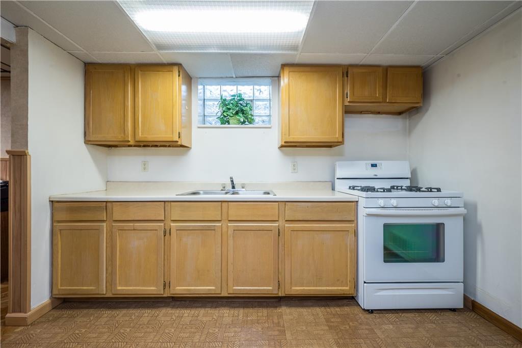 451 Horning Road Pittsburgh, PA 15236 - Photo 39 of 48 Kitchenette in basement has storage and stove for holiday baking or entertaining in the family room on game day!