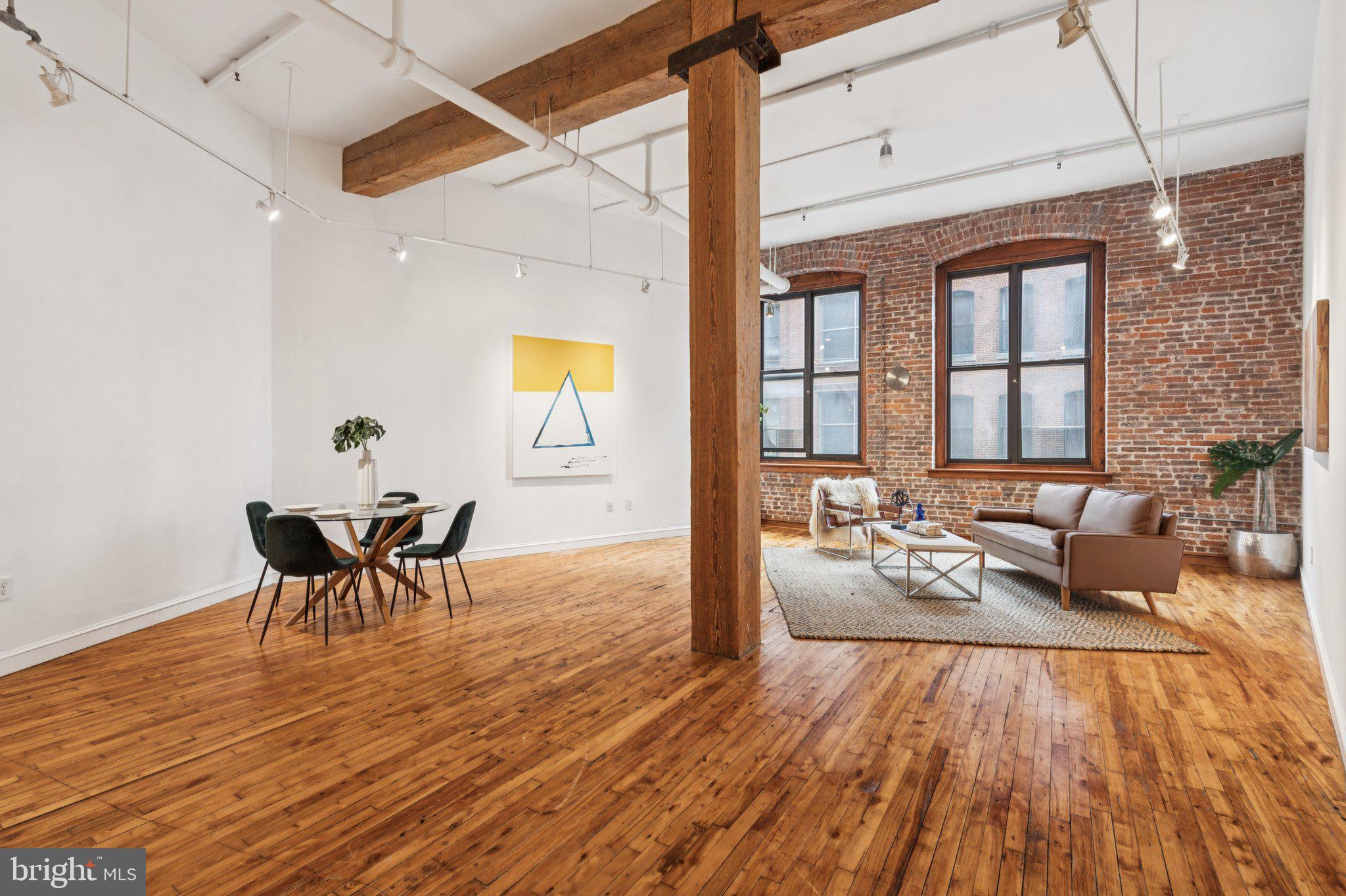 428 North 13th Street, Unit 3F Philadelphia, PA 19123 - Photo 13 of 48 a living room with furniture and a wooden floor