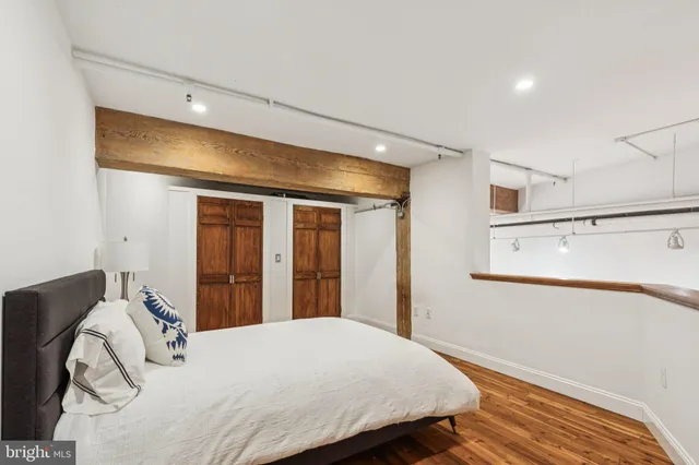 a bedroom with a bed and a large window