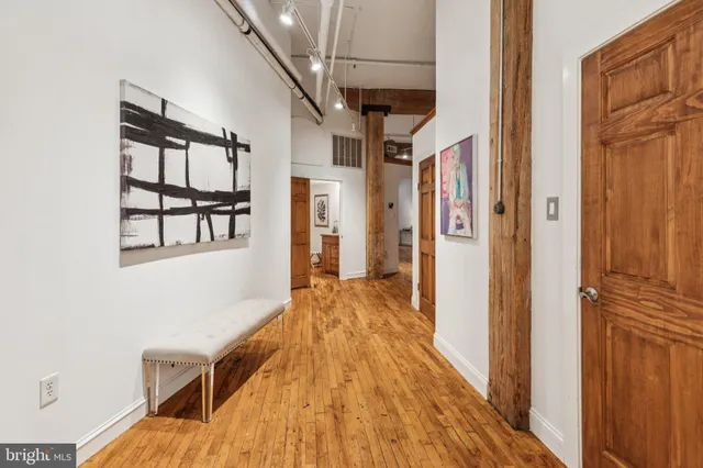 a view of hallway with wooden floor and staircase