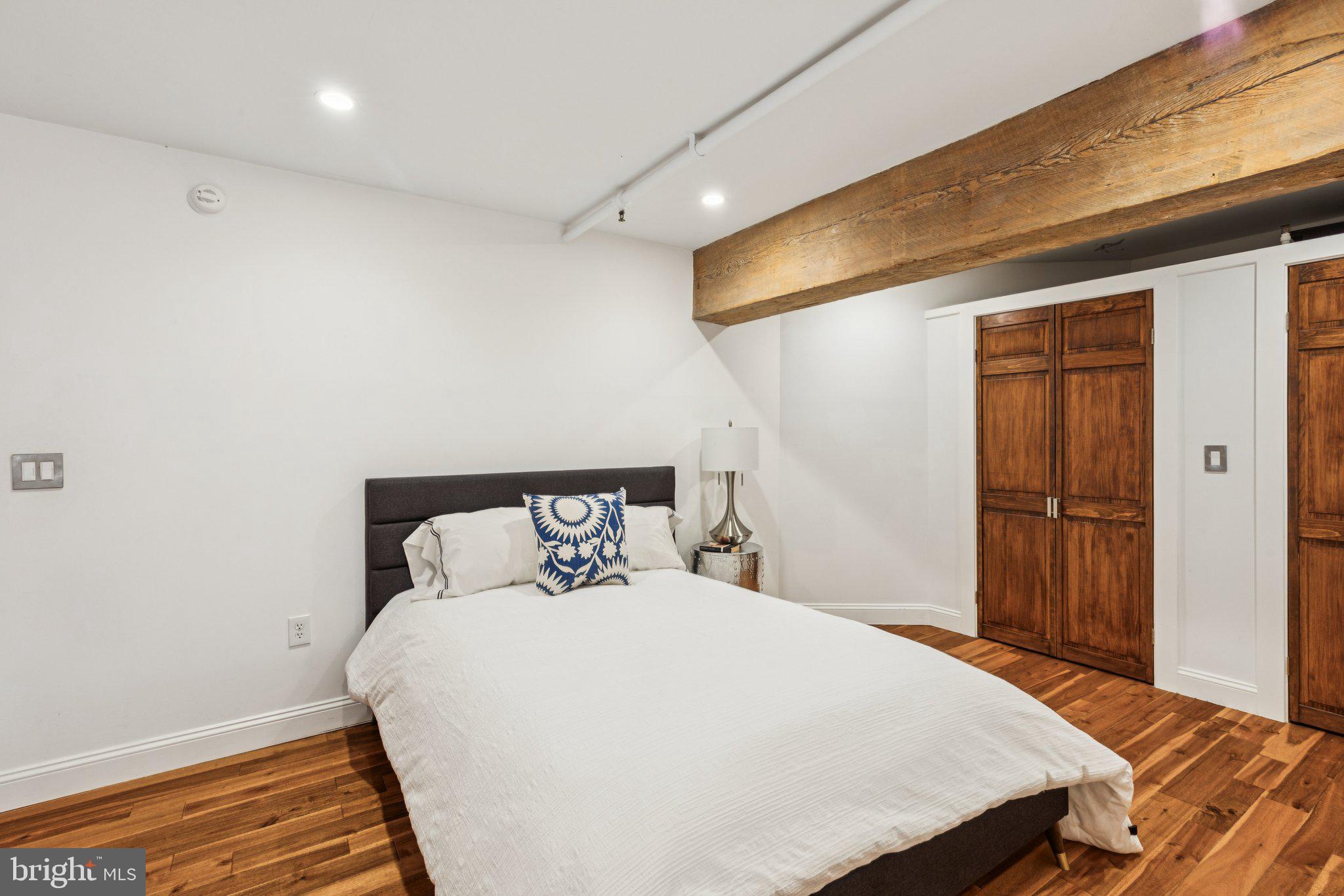 428 North 13th Street, Unit 3F Philadelphia, PA 19123 - Photo 21 of 48 a bedroom with a bed and wooden floor