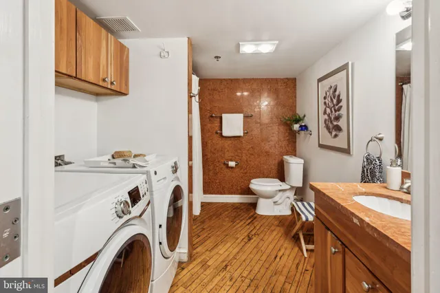 a bathroom with a toilet and a shower curtain