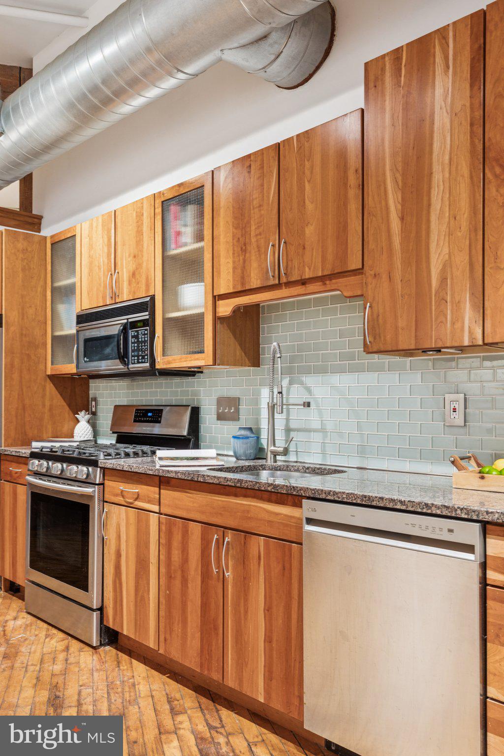 428 North 13th Street, Unit 3F Philadelphia, PA 19123 - Photo 29 of 48 a kitchen with stainless steel appliances granite countertop a sink a stove and cabinets