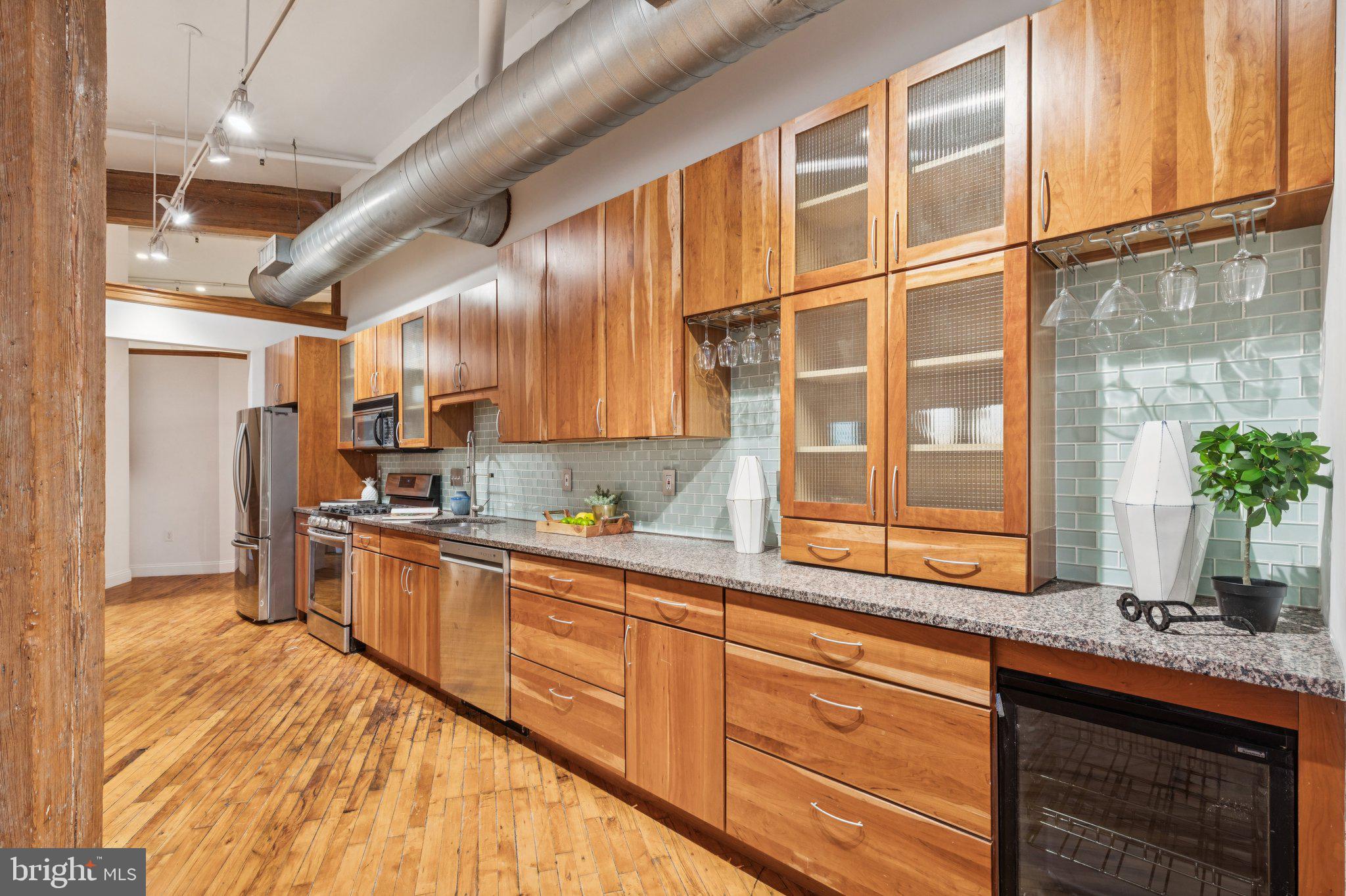 428 North 13th Street, Unit 3F Philadelphia, PA 19123 - Photo 31 of 48 a kitchen with stainless steel appliances granite countertop a sink and cabinets