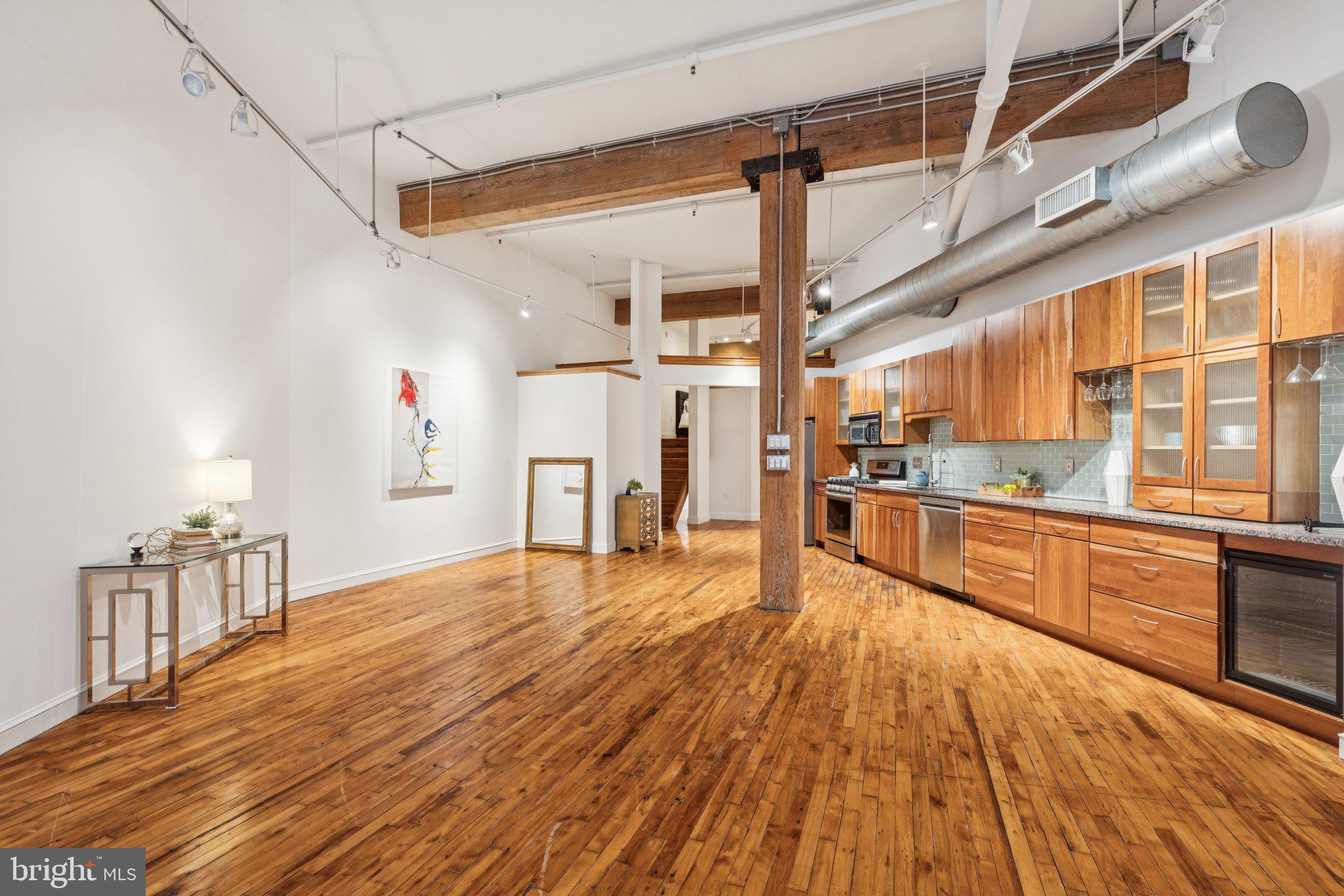 428 North 13th Street, Unit 3F Philadelphia, PA 19123 - Photo 33 of 48 a large kitchen with cabinets wooden floor and stainless steel appliances