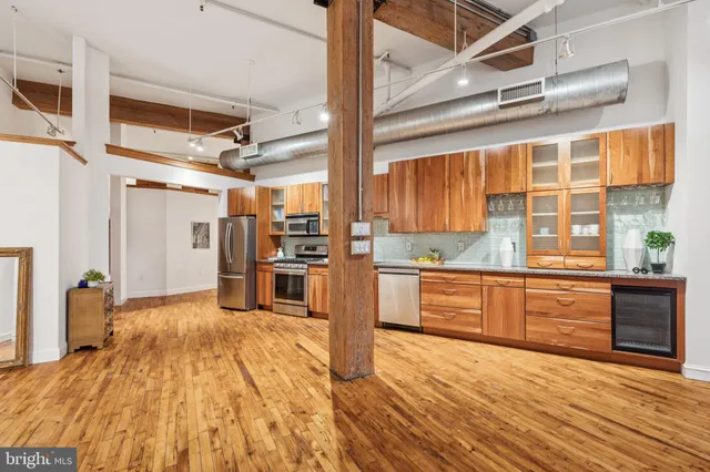 a kitchen with stainless steel appliances granite countertop a refrigerator and a stove top oven