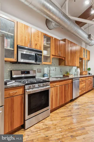 a view of a kitchen with a sink and cabinets