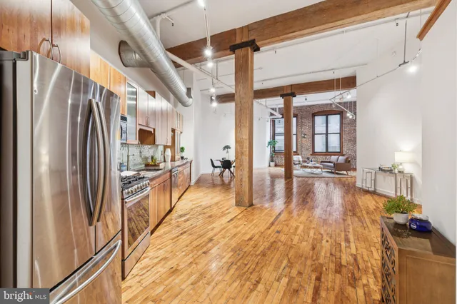 a view of a room with wooden floor