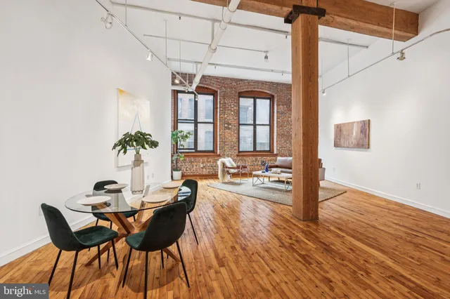 a dining room with furniture and wooden floor