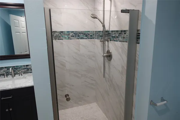 a bathroom with a shower and a sink