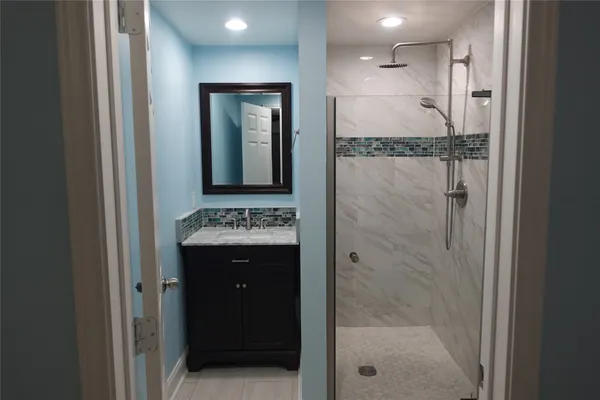 a bathroom with a shower and a sink