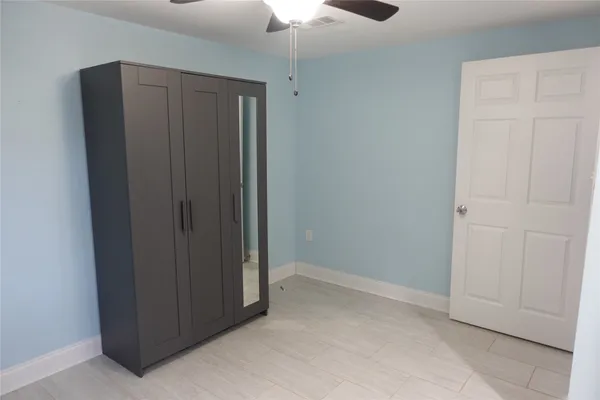 an empty room with closet area