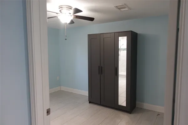 a view of a chandelier fan and hardwood floor