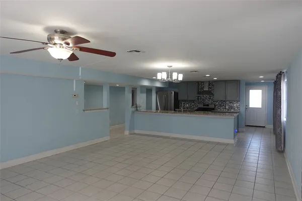 a view of kitchen with refrigerator and window