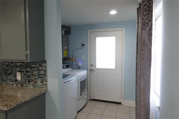 a room with a sink and cabinets