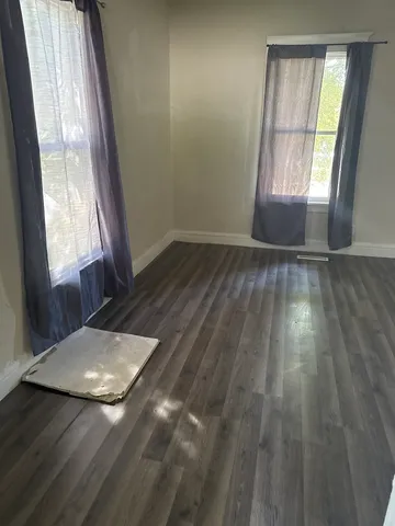 a view of wooden floor and windows in a room