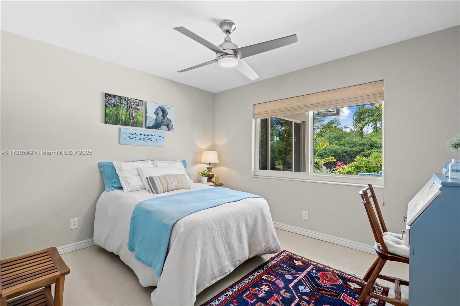 425 Northeast 29th Street Wilton Manors, FL 33334 - Photo 21 of 30 a bedroom with a bed and a large window