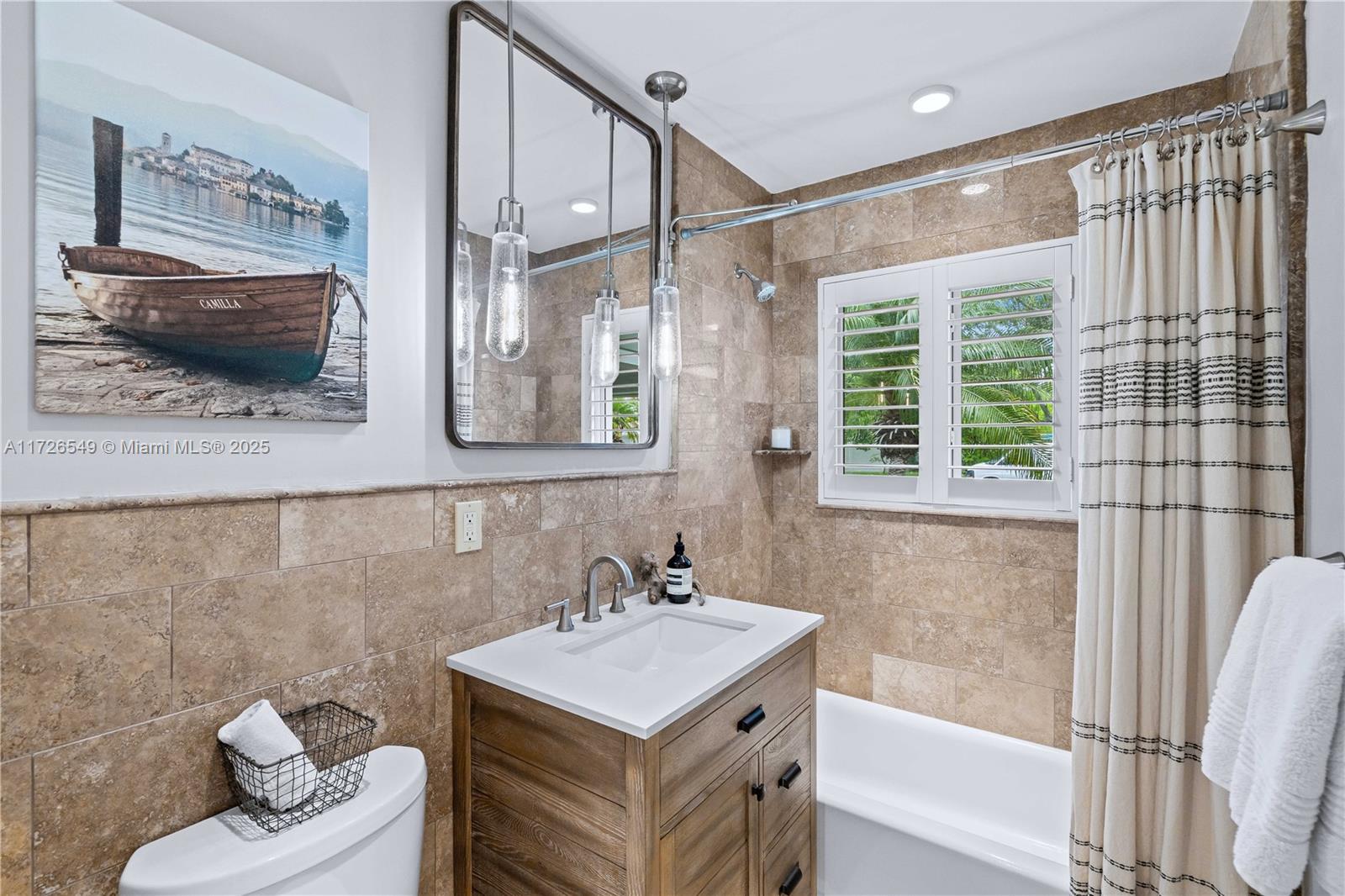 425 Northeast 29th Street Wilton Manors, FL 33334 - Photo 22 of 30 a bathroom with a sink a toilet and a bathtub