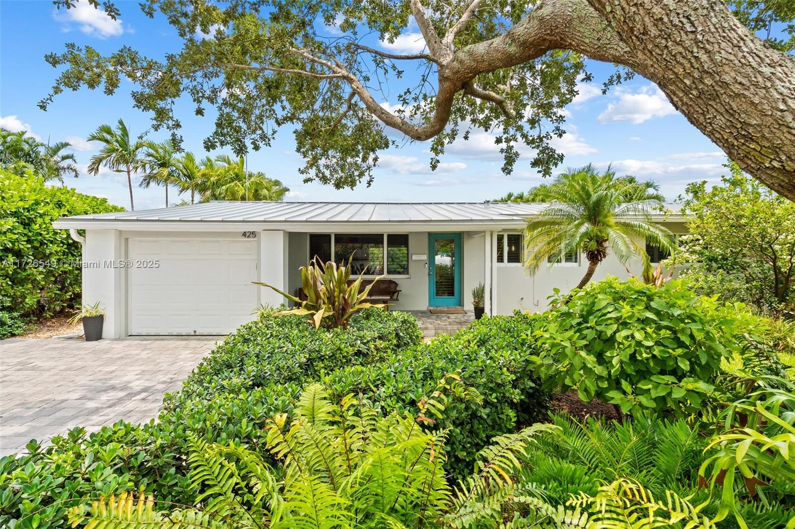 425 Northeast 29th Street Wilton Manors, FL 33334 - Photo 25 of 30 front view of a house with a garden
