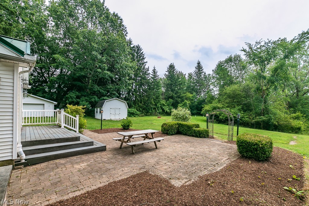 11601 Bass Lake Road Chardon, OH 44024 - Photo 6 of 50 View of patio featuring a garage, a storage shed, and a deck