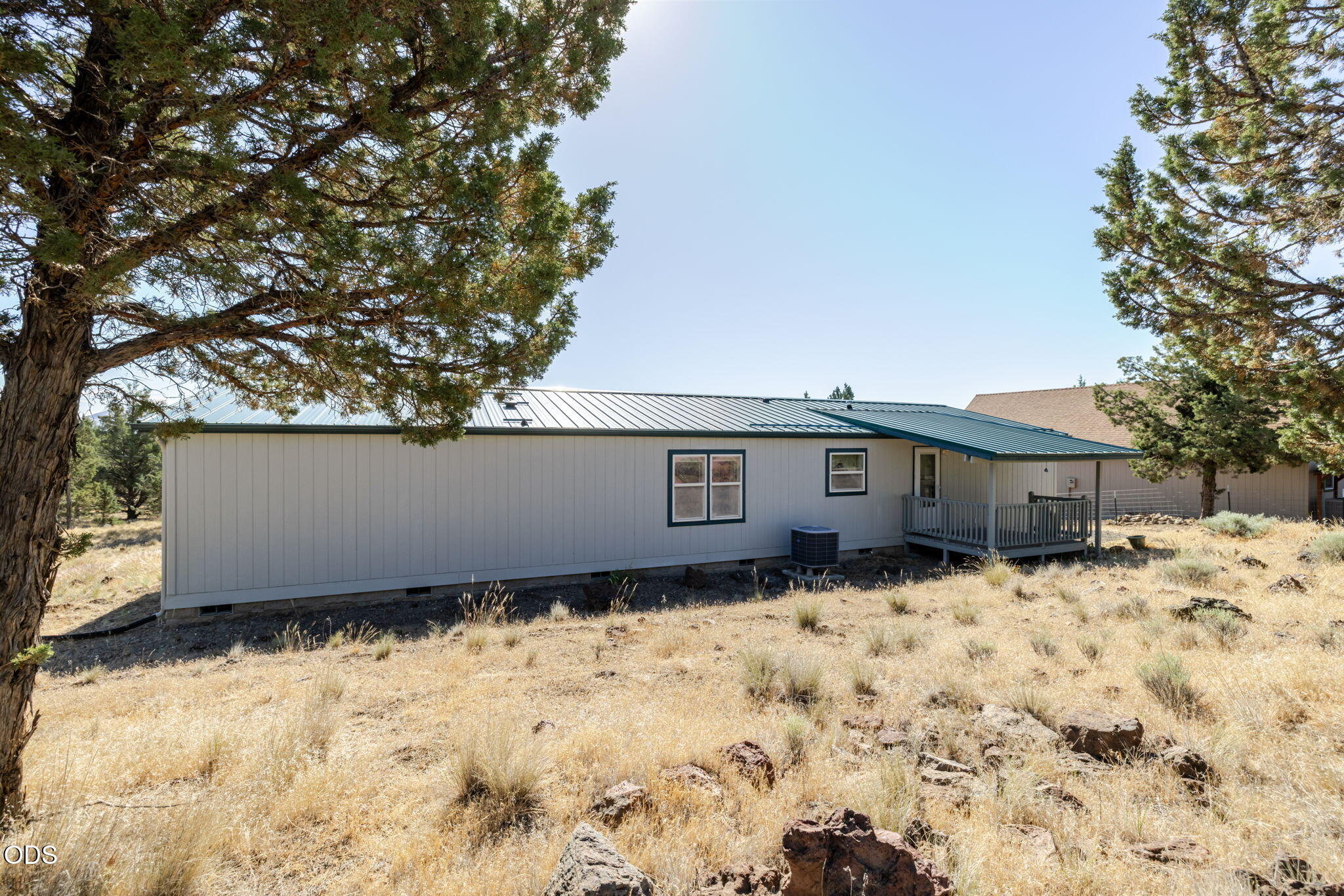 8628 Southwest Crater Loop Road Terrebonne, OR 97760 - Photo 28 of 36 a house with trees in front of it