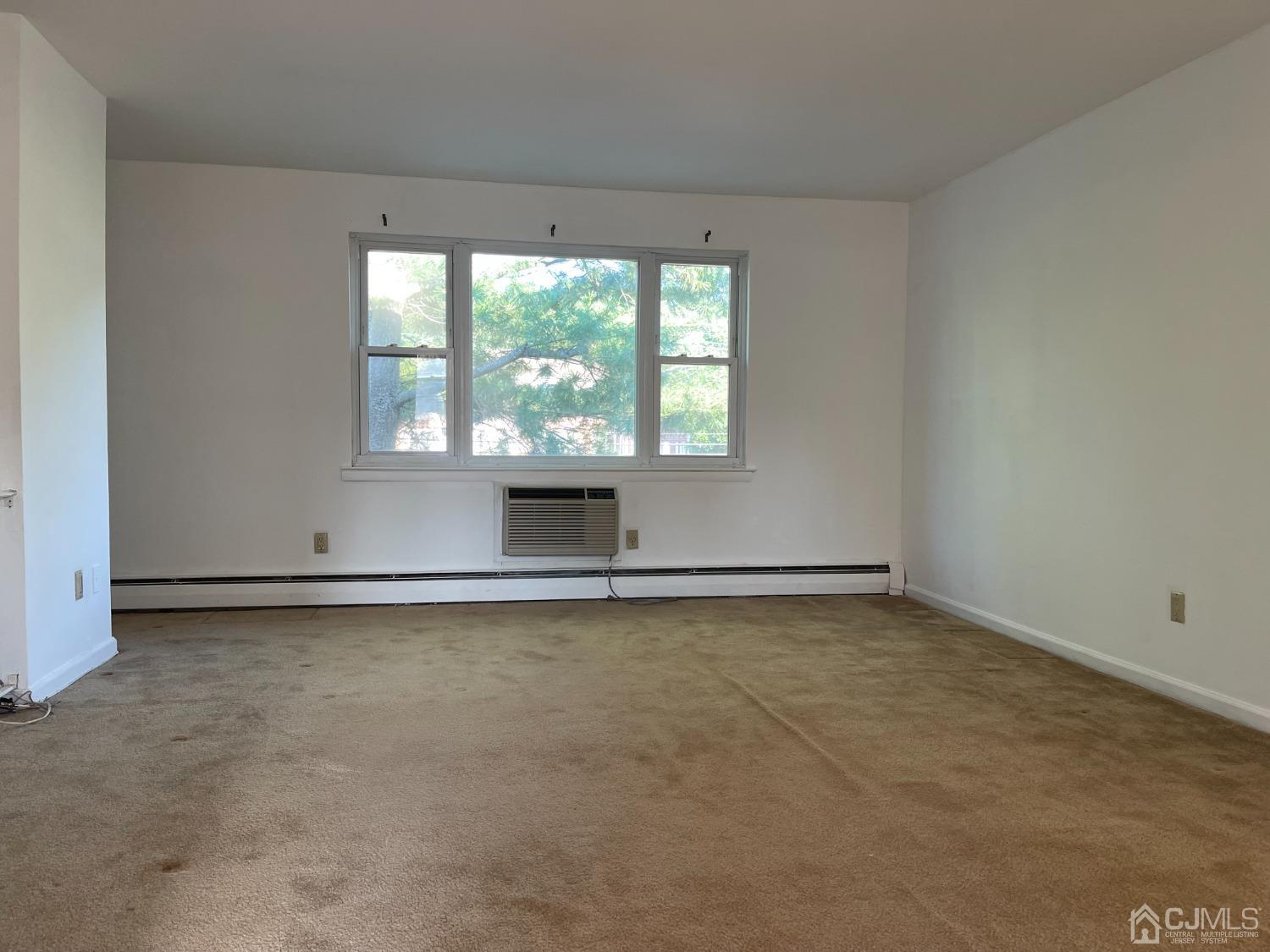 an empty room with a empty space and a window