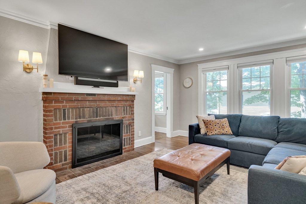30 Perkins Street, Unit 1 Newton, MA 02465 - Photo 14 of 34 a living room with furniture a flat screen tv and a fireplace