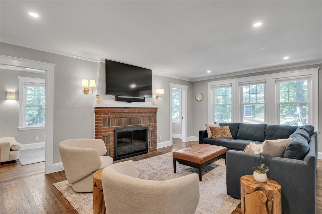 30 Perkins Street, Unit 1 Newton, MA 02465 - Photo 15 of 34 a living room with furniture a flat screen tv and a fireplace