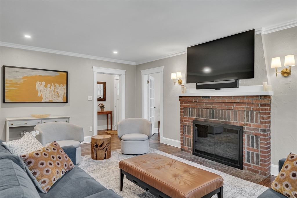 30 Perkins Street, Unit 1 Newton, MA 02465 - Photo 16 of 34 a living room with furniture a flat screen tv and a fireplace