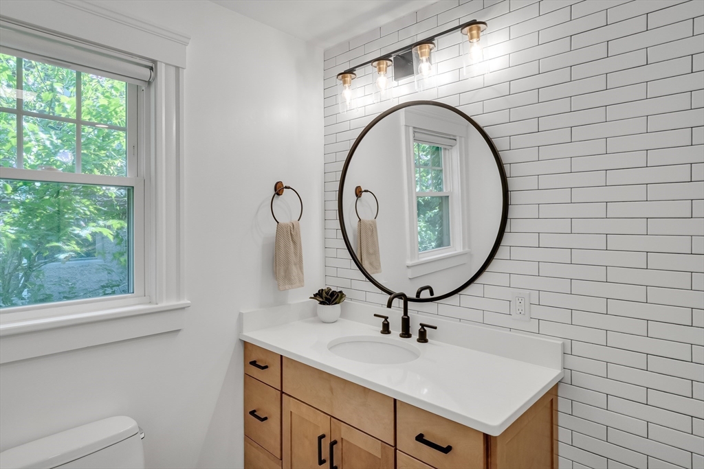 30 Perkins Street, Unit 1 Newton, MA 02465 - Photo 18 of 34 a bathroom with a sink a mirror and a window