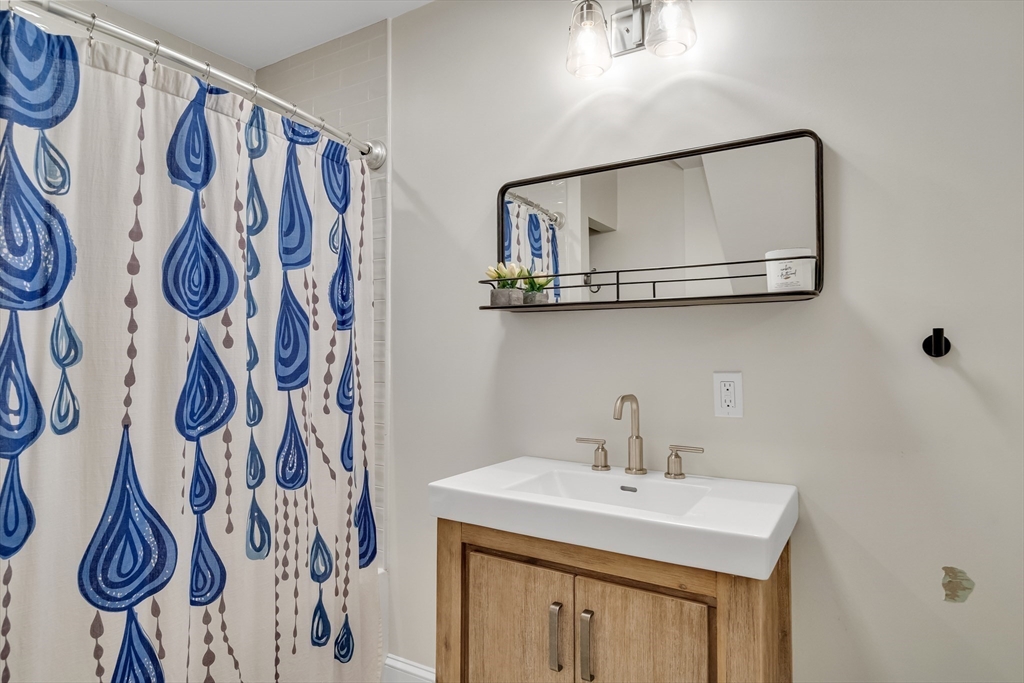 30 Perkins Street, Unit 1 Newton, MA 02465 - Photo 24 of 34 a bathroom with a sink and a mirror