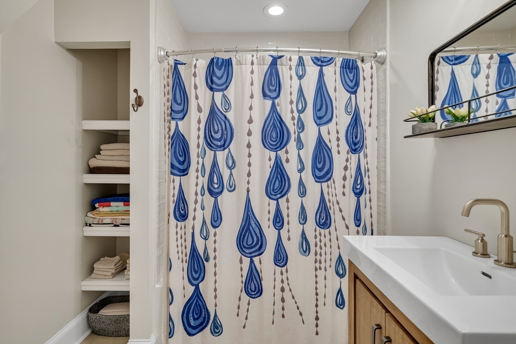 30 Perkins Street, Unit 1 Newton, MA 02465 - Photo 25 of 34 a bathroom with a sink and a mirror