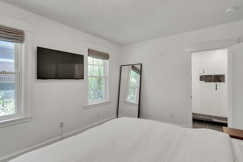 30 Perkins Street, Unit 1 Newton, MA 02465 - Photo 27 of 34 a bedroom with a bed and a flat screen tv
