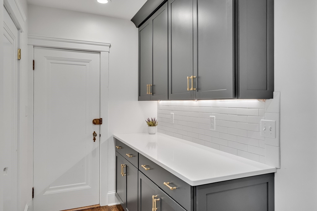 30 Perkins Street, Unit 1 Newton, MA 02465 - Photo 7 of 34 a bathroom with a sink and a mirror